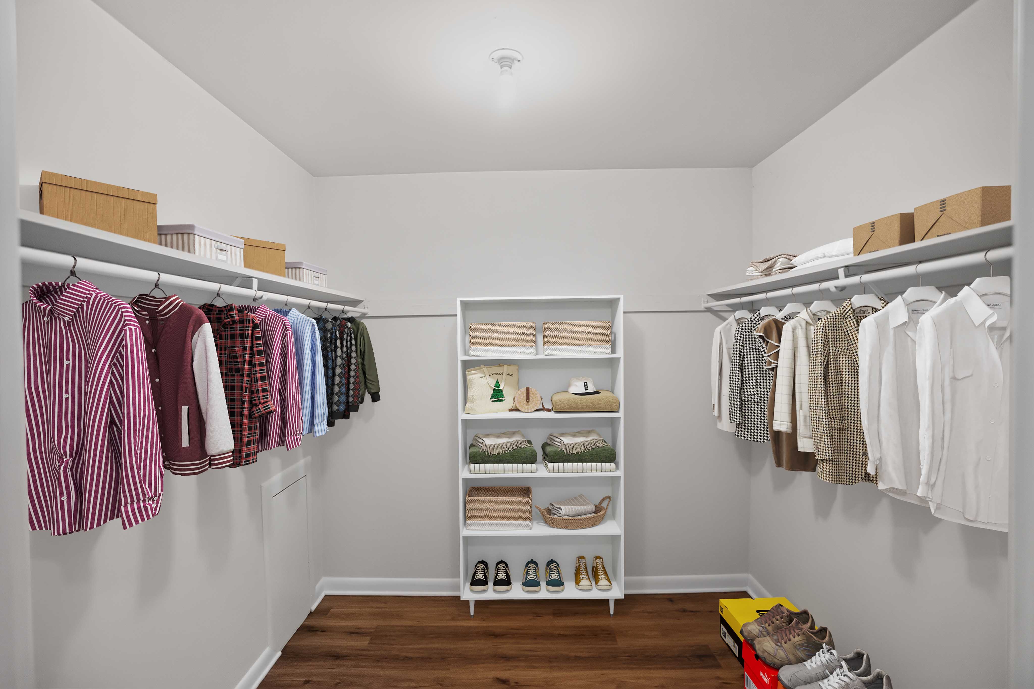 A white closet with clothes and shoes.